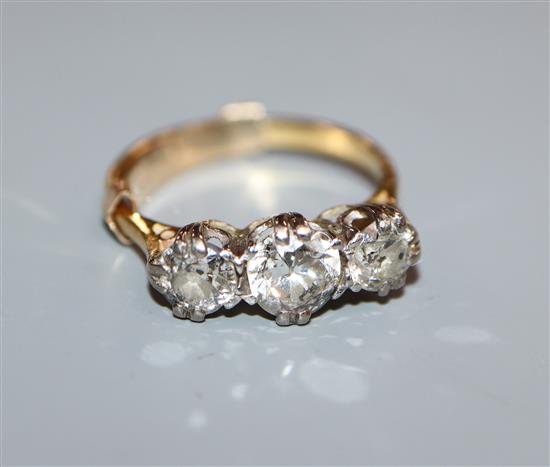 A yellow metal and three stone diamond ring, size H.